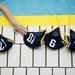 A Michigan player reaches for a cap before the game against Indiana on Saturday, April 27. Daniel Brenner I AnnArbor.com